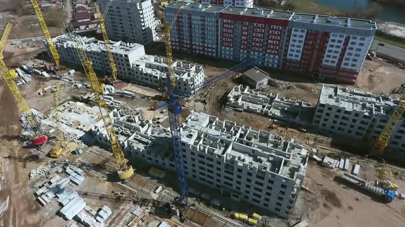 Aerial of Construction Site with Cranes Near Multistory Buildings