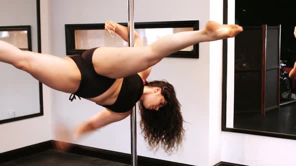 Pole dancer practicing pole dance