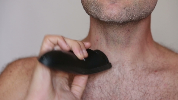 A Shirtless Man Shaving