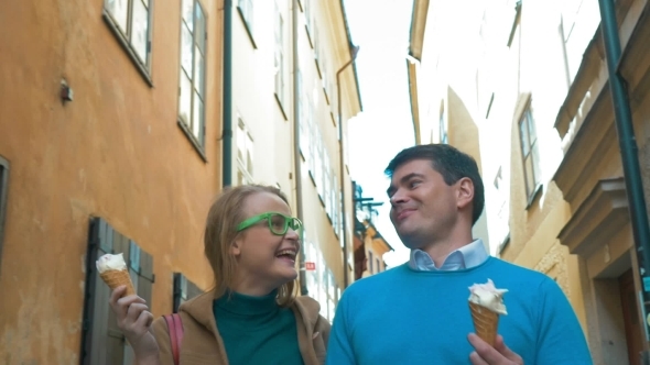 Couple Walking And Eating Ice-Cream