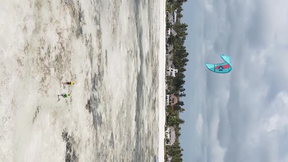 Vertical Video Kitesurfing Near the Shore of Zanzibar Tanzania Aerial View