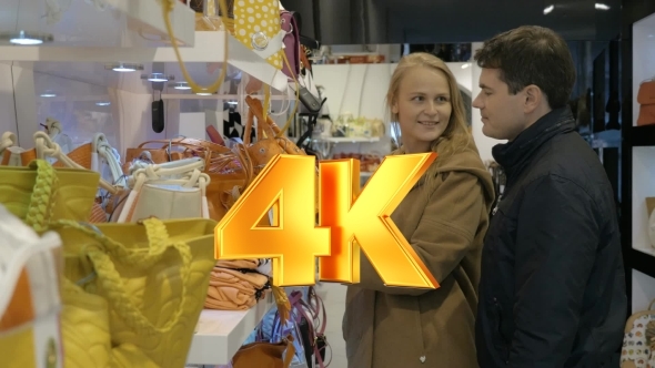 Young Couple Examining Handbags In The Store