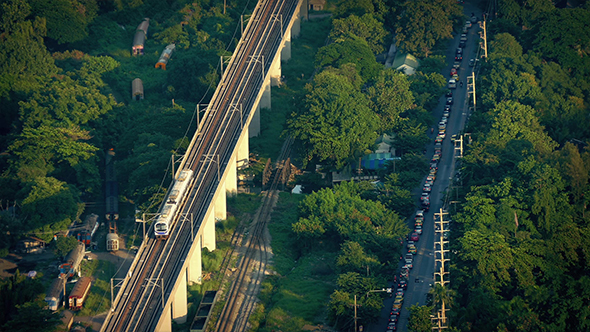 Subway Passing Train Yard And Road Outside City