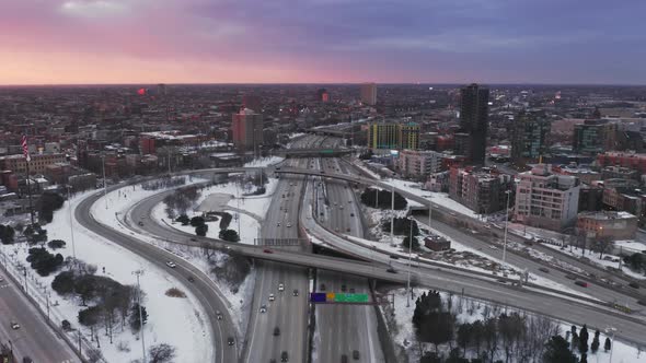 Scenic Pink and Purple Sunset Over Winter Chicago Suburban Highway  Aerial