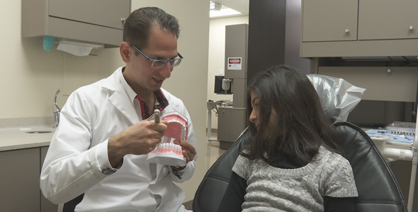 Dentist Shows Young Girl How To Brush Two Pack