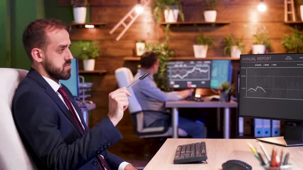 Portrait of Smiling Businessman Working Late Night Hours in Cozy Office