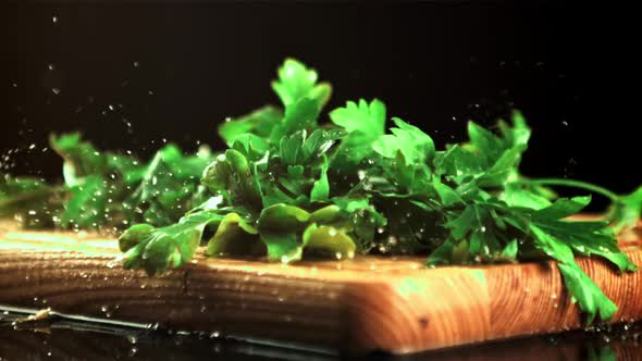 A Bunch of Parsley Falls on the Cutting Board