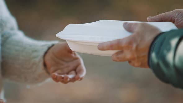 Woman Volunteer Help Feed the Homeless with Free Meal. Close-Up. 