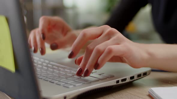 Young Blonde Woman Typing Text on Laptop Keyboard