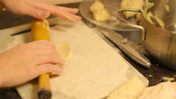 Rolling Out Dough With a Rolling Pin In Hand