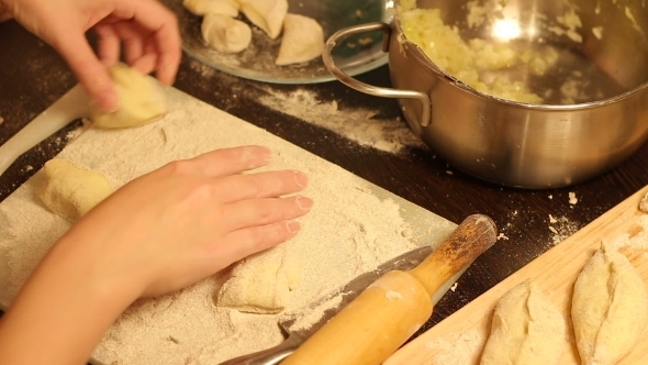 Rolling Out Dough With a Rolling Pin In Hand