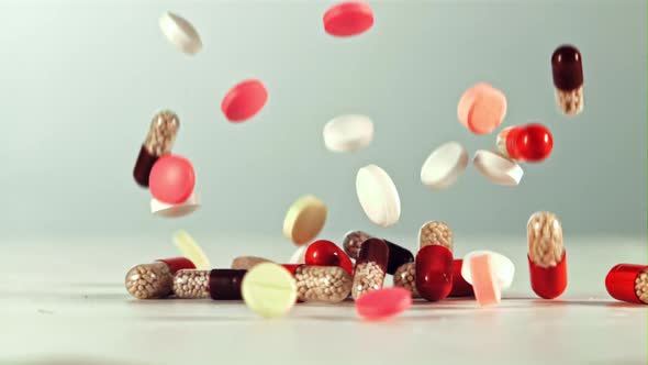 Different Types of Pills Fall on the Table