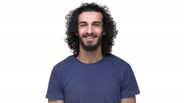 Portrait of Brazilian Guy with Curly Hair in Casual Dark Blue Tshirt Smiling While Being in Good