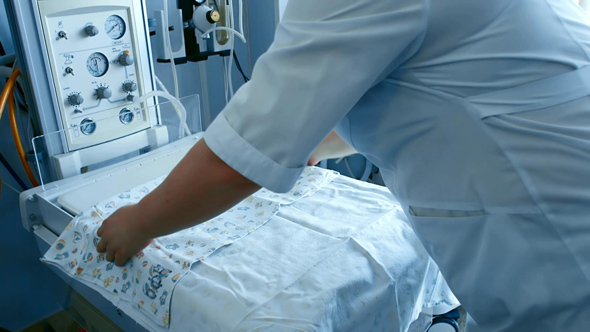 Nurse Covered Incubator with Blankets and Diapers