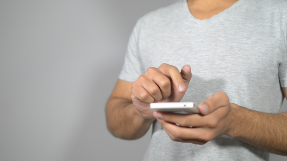 Busy Young Man on Smartphone , Browsing, Scrolling alt