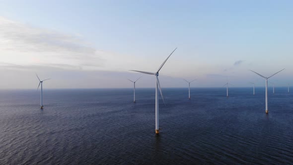 Offshore Windmill Park with Clouds and a Blue Sky Windmill Park in the Ocean Drone Aerial View with