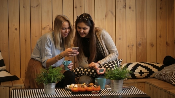 Beautiful Girls Sitting In Cafe With Tea And