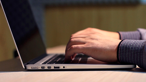 Man Typing On Laptop