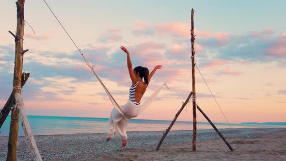  Girl on the Swing in front of the Ocean