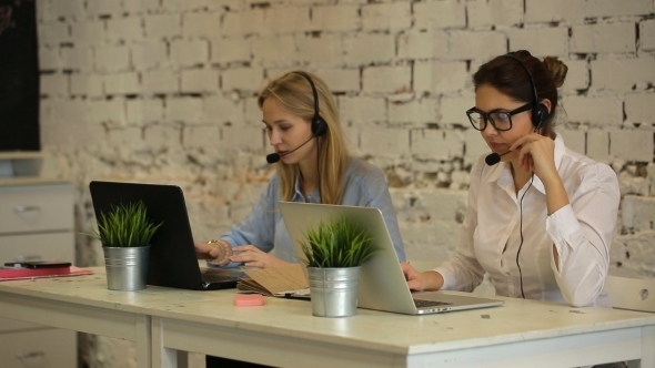 Two Customer Service Representatives At Work