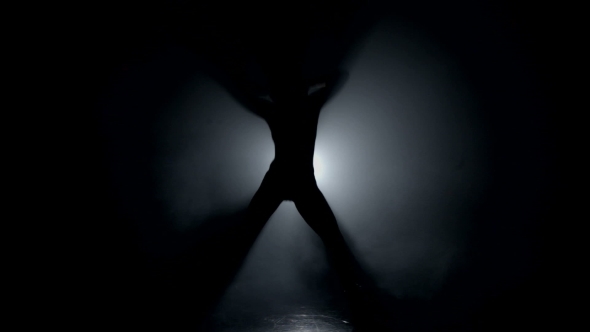 Silhouette Of Girl Dancing Actively In The Dark