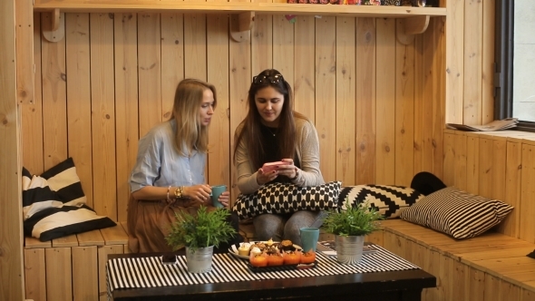 Beautiful Girls Sitting In Cafe With Tea And