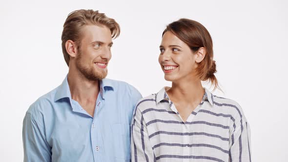 Beautiful Caucasian Pair Standing Flirting Ogle on White Background