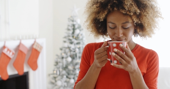 Pretty Young African Woman Enjoying Coffee