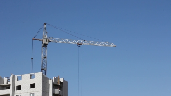 Tower Cranes Against Blue Sky, With Clouds
