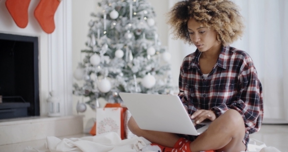 Young African Woman Relaxing At Christmas Time