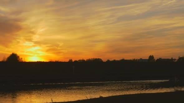 River Water Flows Bright Yellow Sunset at The