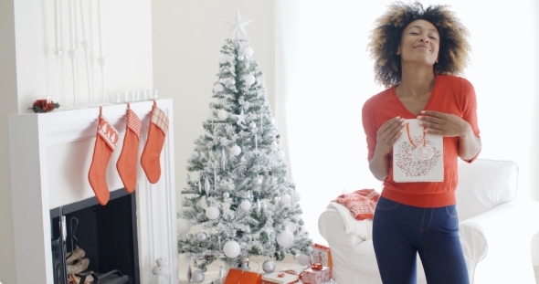 Blissfully Happy Young Woman With a Xmas Gift