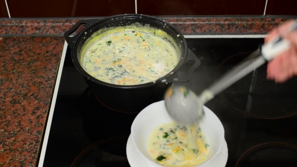 Woman Pours Cheese Soup In Bowl