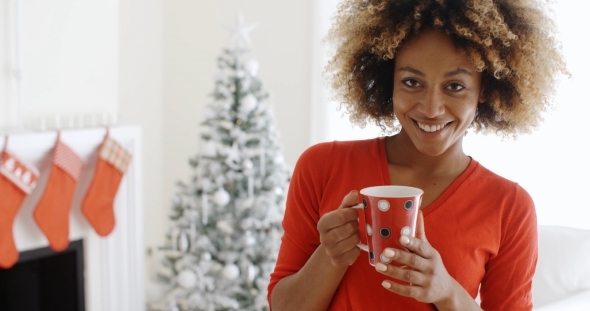 Pretty Young African Woman Enjoying Coffee