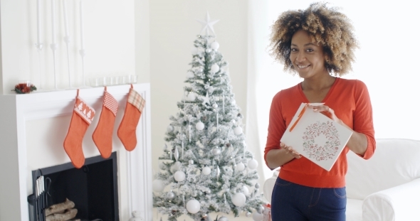 Blissfully Happy Young Woman With a Xmas Gift