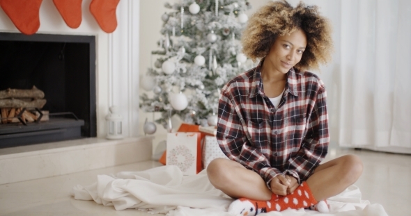 Trendy Young Woman In Front Of a Christmas Tree