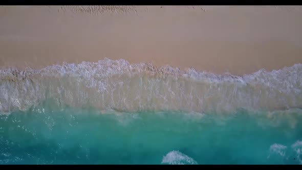 Aerial scenery of tropical coastline beach voyage by blue lagoon and white sandy background of journ