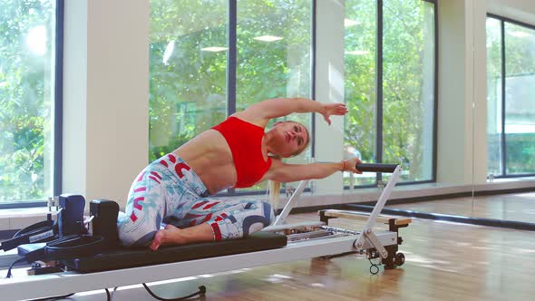 Girl Exercising Pilates at Fitness Club
