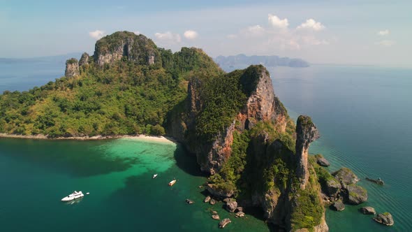 aerial drone panning forward over Ko Kai (Chicken Head Island) surrounded by tropical turquoise blue