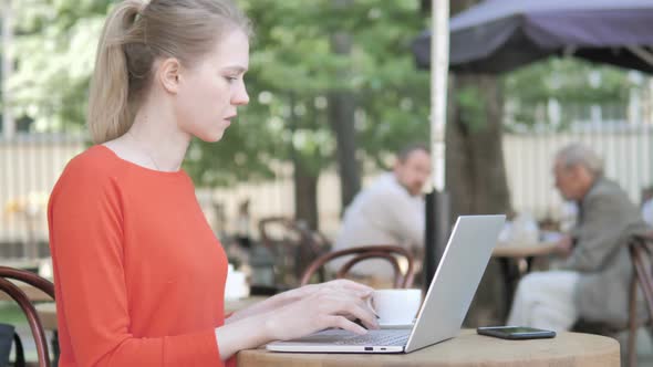 Woman Working on Laptop and Drinking Coffee Outdoor