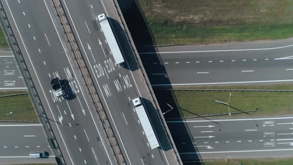 Convoy of Trucks Ride on the Highway Bridge, Road Junction Near Forest, Logistic Transportation