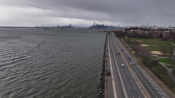 An aerial view over the paved walkway along the Belt Parkway by Upper Bay in Brooklyn NY. The drone