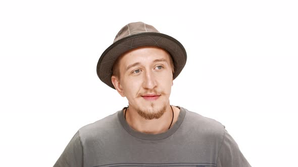 Young Handsome Man in Hat Smiling Thinking Over White Background