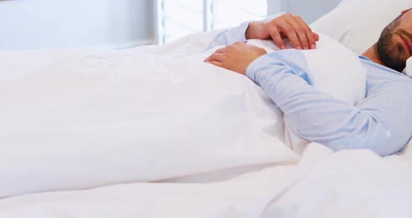 Man sleeping on bed in bedroom