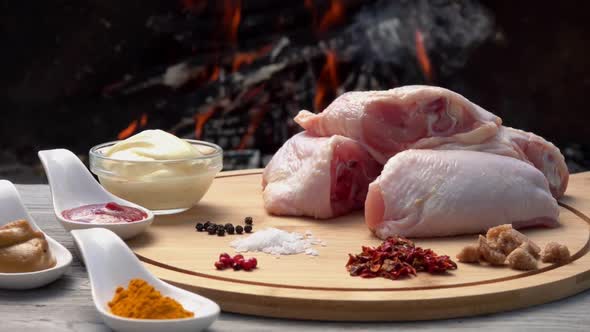 Ingredients for Preparation of Juicy Grilled Chicken Legs on Background of Fire