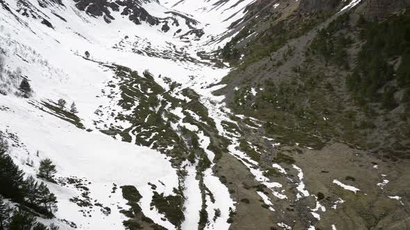 Aerial View of a Partially Snow Covered Gorge for a Late Spring Freeride