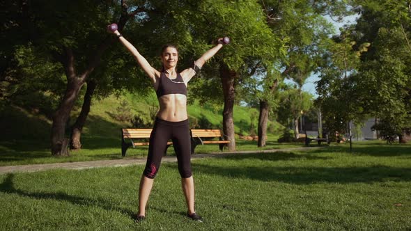 Young Beautiful Sportive Girl Training in Park