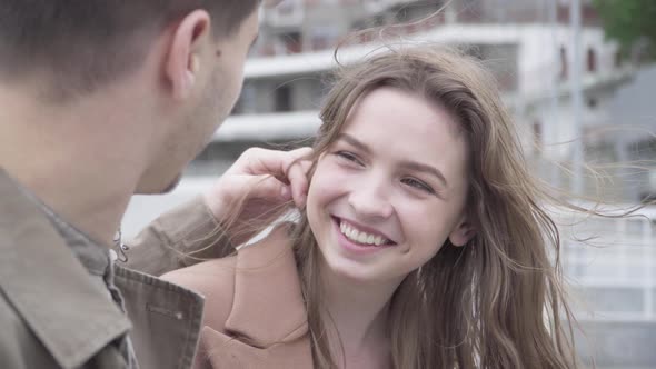 Portrait of Laughing Happy Brunette Girl Dating Outdoors with Boyfriend. Loving Young Caucasian Man