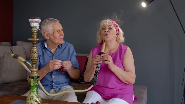 Stylish Senior Couple Enjoy Smoking Hookah, Eating Fruits at Home, Celebrating, Having Fun Together