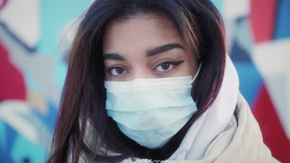 Closeup Portrait of Young African American Girl Wearing Medical Mask Standing Outdoors Alone Looking